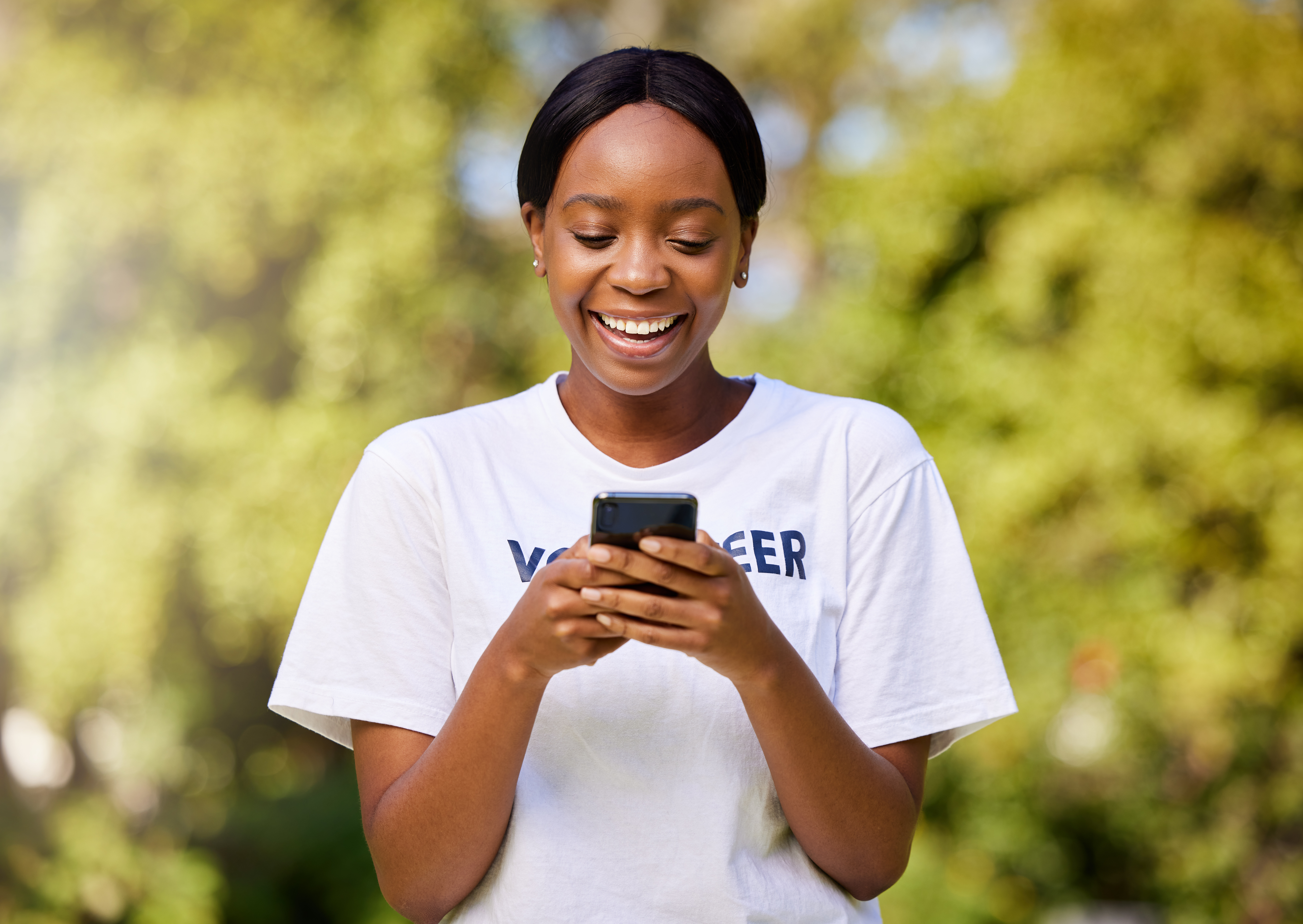 Chat, park volunteering and black woman with a phone for social media, email or communication. Happ